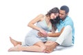 A young black man helps his white wife with birth pain with a ball. Partnered birth, partnered delivery. Isolated white