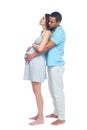 A young black man helps his white wife with birth pain with a ball. Partnered birth, partnered delivery. Isolated white