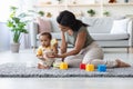 Young black mother and her baby boy playing with toys at home Royalty Free Stock Photo