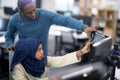Young black muslim female software developer at work
