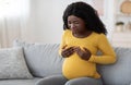 Sad pregnant black woman having painful feelings in breast Royalty Free Stock Photo