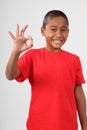 Young black school boy 9 gives happy okay sign