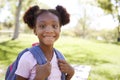 Young black schoolgirl smiling to camera, portrait