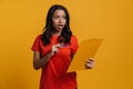 Young black surprised woman posing with clipboard