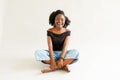 Young black woman with afro hairstyle smiling. Girl wearing black. Studio shot Royalty Free Stock Photo