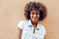 Young black woman, afro hairstyle, smiling in urban background Royalty Free Stock Photo