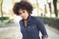 Young black woman with afro hairstyle standing in urban background Royalty Free Stock Photo