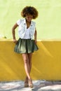 Young black woman, afro hairstyle, standing in urban background Royalty Free Stock Photo