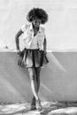 Young black woman, afro hairstyle, standing in urban background Royalty Free Stock Photo