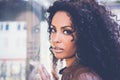 Young black woman, afro hairstyle, in urban background