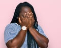 Young black woman with braids wearing casual clothes with sad expression covering face with hands while crying Royalty Free Stock Photo