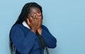 Young black woman with braids wearing casual clothes with sad expression covering face with hands while crying Royalty Free Stock Photo