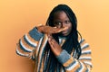 Young black woman with braids wearing casual winter sweater doing time out gesture with hands, frustrated and serious face Royalty Free Stock Photo