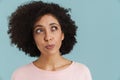 Young black woman with curly hair thinking and looking aside Royalty Free Stock Photo