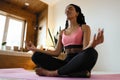 Young black woman doing yoga at home in the lotus position. Royalty Free Stock Photo