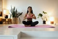 Young black woman doing yoga at home in the lotus position. Royalty Free Stock Photo