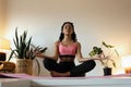 Young black woman doing yoga at home in the lotus position. Royalty Free Stock Photo