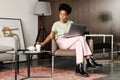 Young black woman drinking coffee while working with laptop Royalty Free Stock Photo