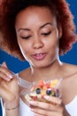 Young Black woman eating a healthy fresh fruit salad Royalty Free Stock Photo