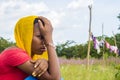 young black woman feeling sad and unhappy squatting outdoor close up