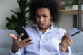 Young black woman having problems with paying online by card