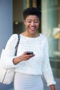 Young black woman laughing and reading text message Royalty Free Stock Photo