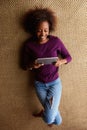 Young black woman lying down with digital tablet Royalty Free Stock Photo