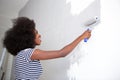 Young black woman painting wall at home Royalty Free Stock Photo