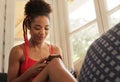 Young Black Woman Reading Phone Message And Smiling