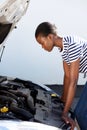 Young black woman on the road trying to fix the broken down car Royalty Free Stock Photo