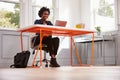 Young black woman sitting at a desk using a laptop computer Royalty Free Stock Photo