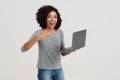 Young black woman smiling and pointing finger at her laptop Royalty Free Stock Photo