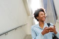 Young black woman on steps with mobile phone Royalty Free Stock Photo