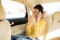 Young black woman talking on phone in car Royalty Free Stock Photo