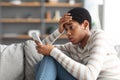 Young Black Woman Upset After Reading Bad Message On Smartphone At Home Royalty Free Stock Photo