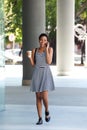 Young black woman walking in city with mobile phone Royalty Free Stock Photo