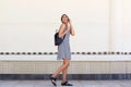 Young black woman walking on street with mobile phone Royalty Free Stock Photo