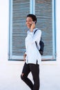 Young black woman walking and talking on cell phone Royalty Free Stock Photo