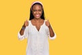 Young black woman wearing casual clothes success sign doing positive gesture with hand, thumbs up smiling and happy Royalty Free Stock Photo