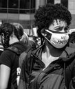 A Young Black Woman Wears a Mask With the Words `We Matter` Written on It Royalty Free Stock Photo