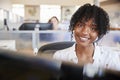 Young black woman working in a call centre smiling to camera Royalty Free Stock Photo