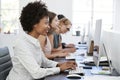 Young black woman working at computer in office with headset Royalty Free Stock Photo