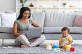 Young Black Woman Working On Laptop And Taking Care Of Infant Child Royalty Free Stock Photo