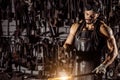 Young blacksmith forging molten metal Royalty Free Stock Photo