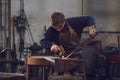 Young blacksmith working with red hot metal Royalty Free Stock Photo