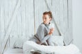 Young blogger or business woman working at home with social media, drinking coffee in early morning in bed Royalty Free Stock Photo