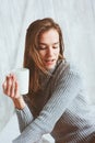 Young blogger or business woman working at home with social media, drinking coffee in early morning in bed Royalty Free Stock Photo