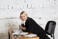 Young blond beauty businesswoman sitting at a office table with laptop, notebook and glasses in suit. Business concept. Royalty Free Stock Photo