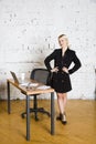 Young blond beauty businesswoman sitting at a office table with laptop, notebook and glasses in suit. Business concept. Royalty Free Stock Photo