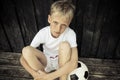 Young blond and blue eyed soccer player in white